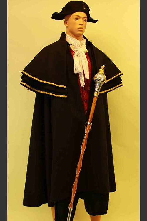 Oliver -Mr Bumble costume. Heavy Inverness style navy coat with gold braiding, Bicorn hat and Mace