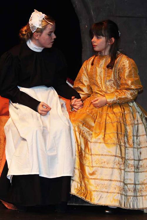 Martha in maid costume with mary in golden dress