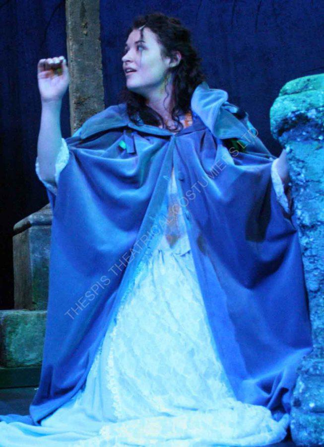 Phantom of the Opera- Christine in Graveyard scene. Wearing  a white flowing wedding dress and long blue hooded velvet cape